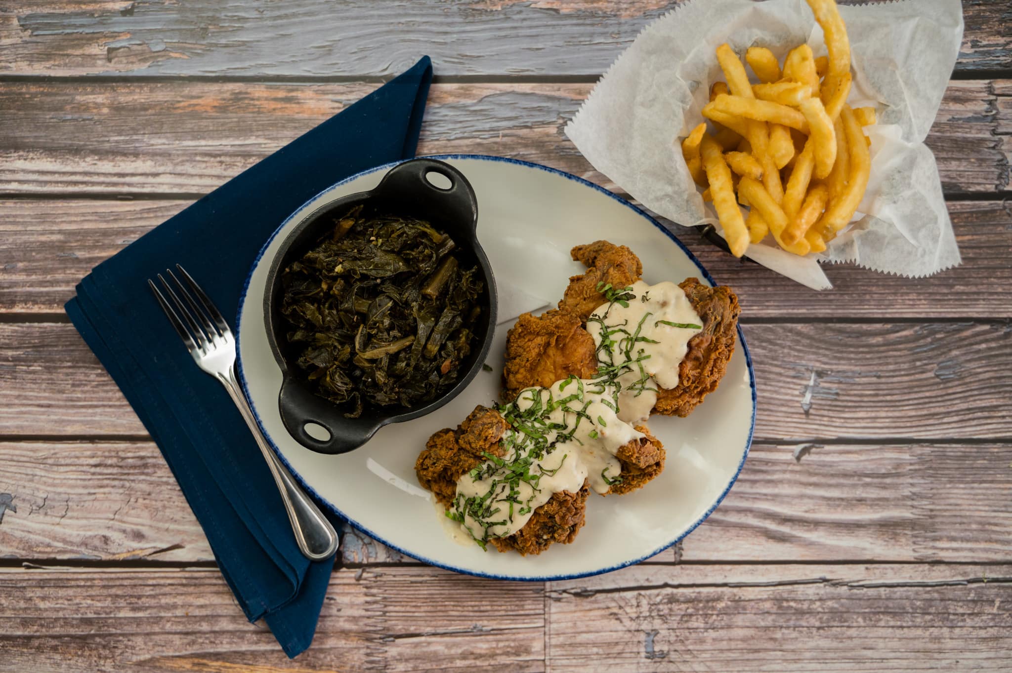 smothered chicken with collards and french fries
